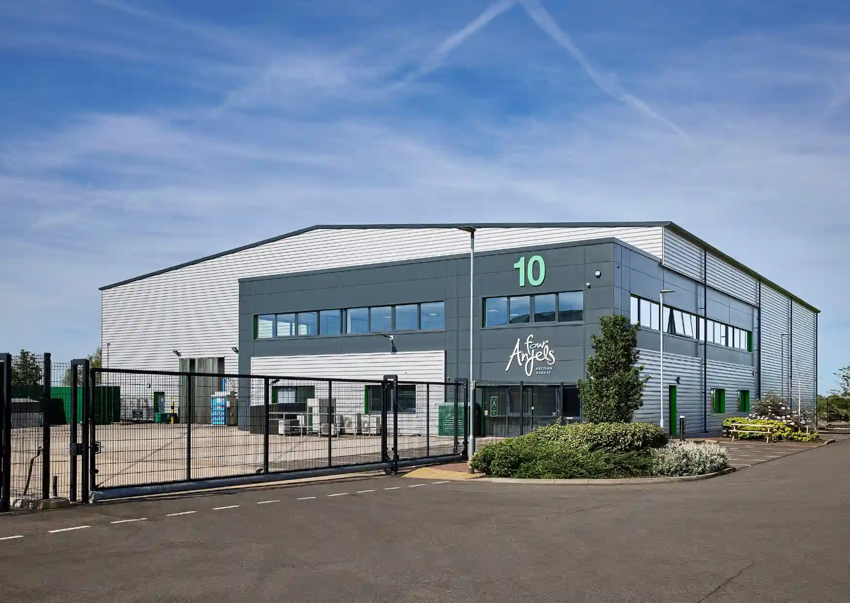Wide shot of a factory unit from the outside. The sign on it says Four Anjels